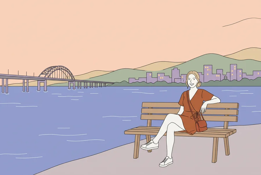 Jeune femme sur un banc au bord du fleuve